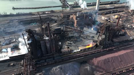 uss steel mill with smoke, steam, molten metals, and machinery