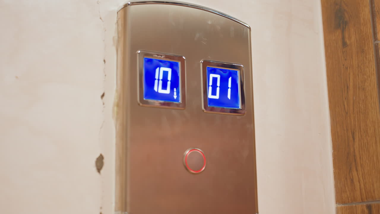 Elevator Panel Blue Digital Display Changing During Sequential Button Presses, Closeup Stainless Metal Face With Glowing Floor Numbers, Hand And Finger Pressing Circular Call Button Scenes Suggest