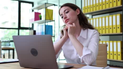 Tired Businesswoman Struggling with Work in Office