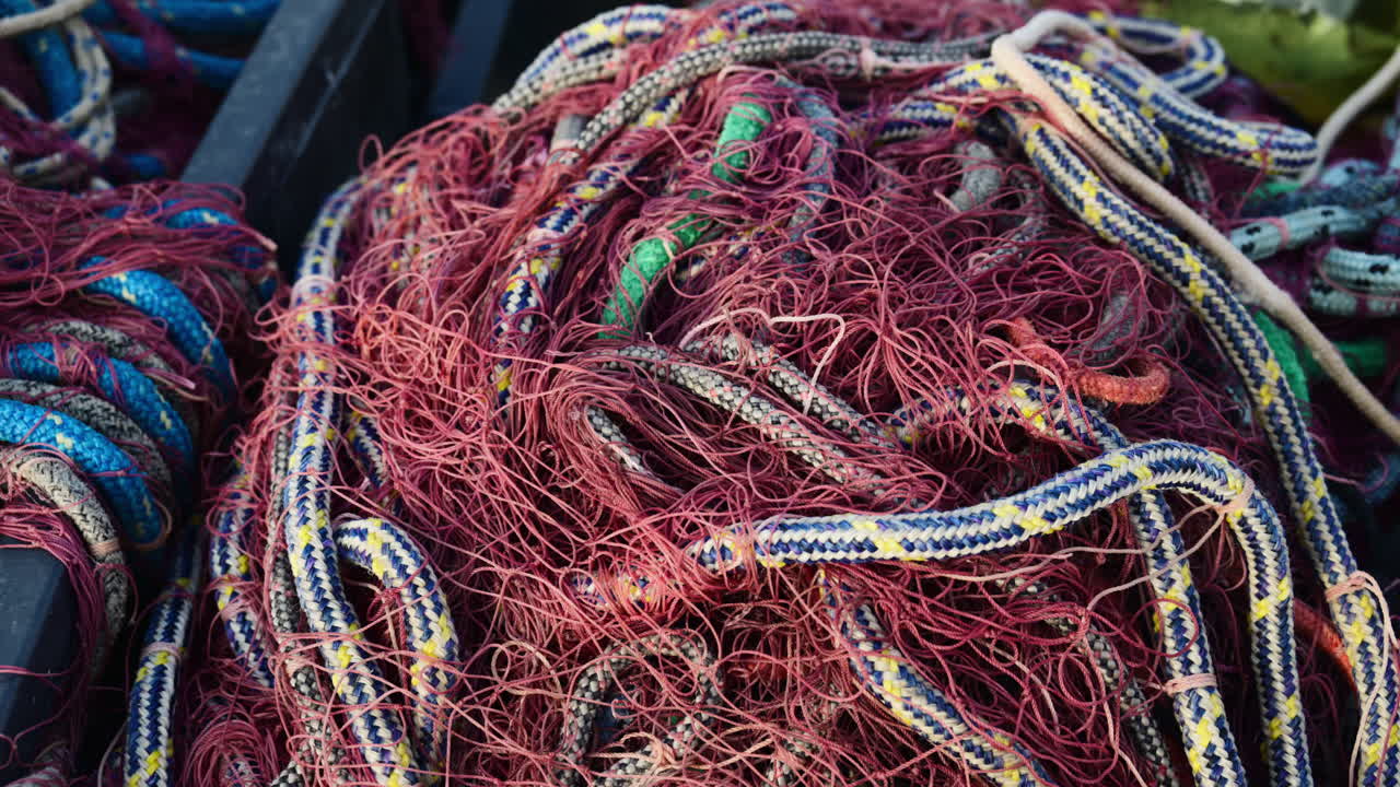 Tangled fishing nets and ropes forming a colorful abstract pattern for maritime themes