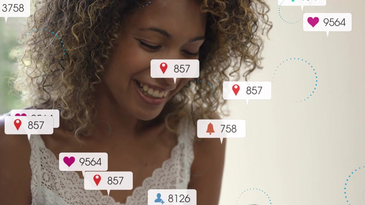 Animation of multiple social media icons against african american woman using smartphone at home