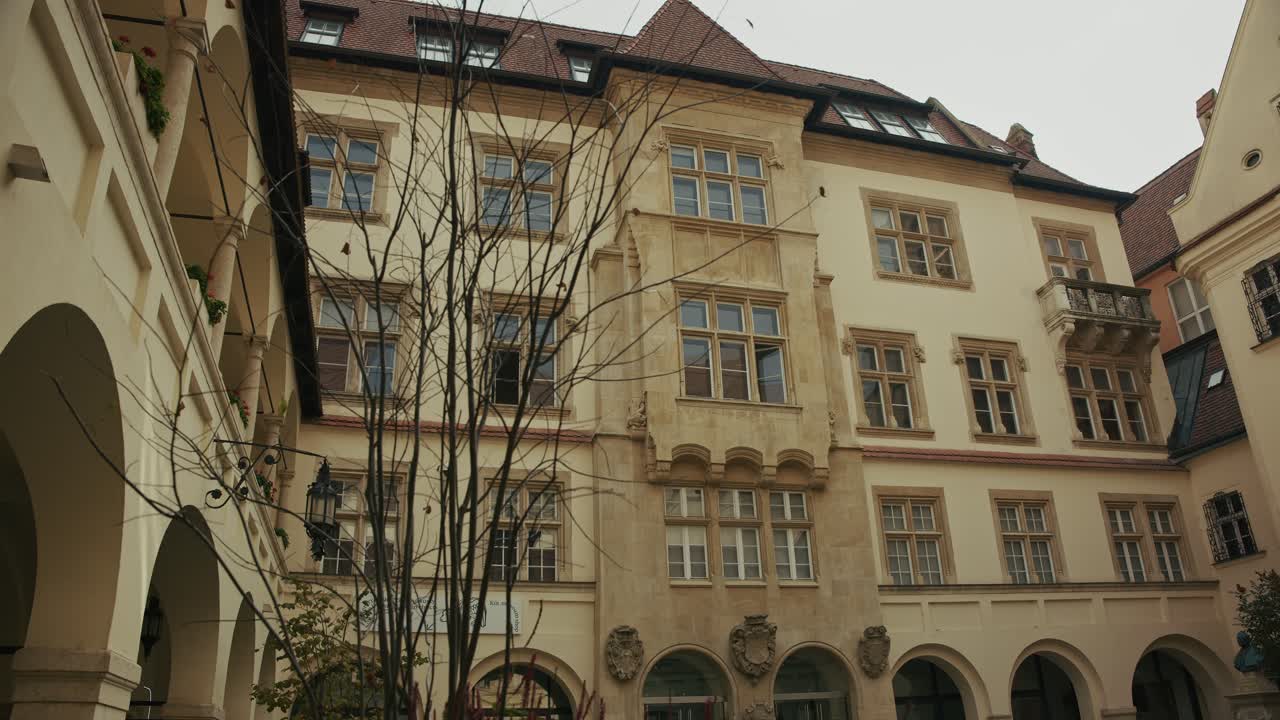 Classic stone facade with arched windows and small balcony in Bratislava