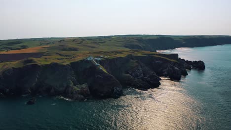 Above-the-Scottish-Coast:-Aerial-View-of-Rocky-Shores-and-Lighthouse