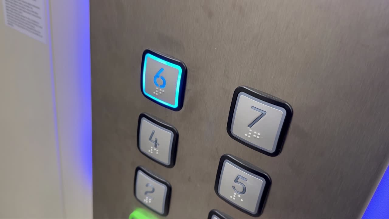 Hand pressing the button in modern lift or elevator