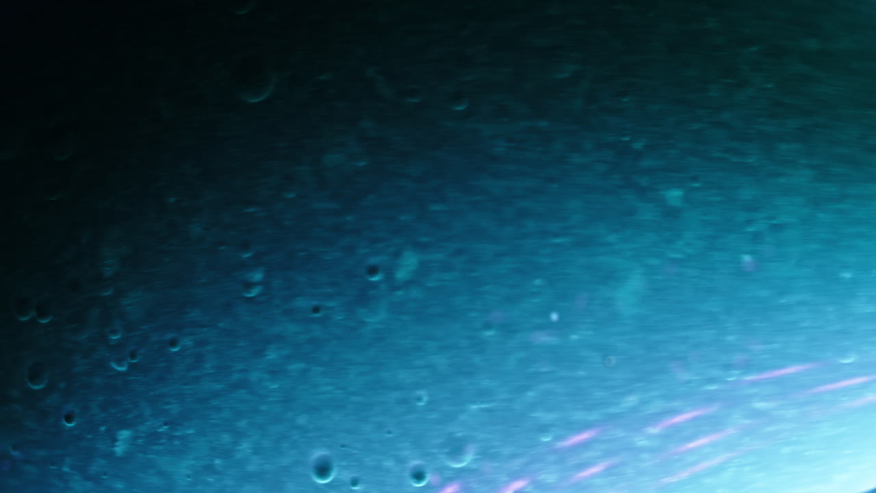 Colorful liquids mixing together in a close-up macro shot, creating mesmerizing textures