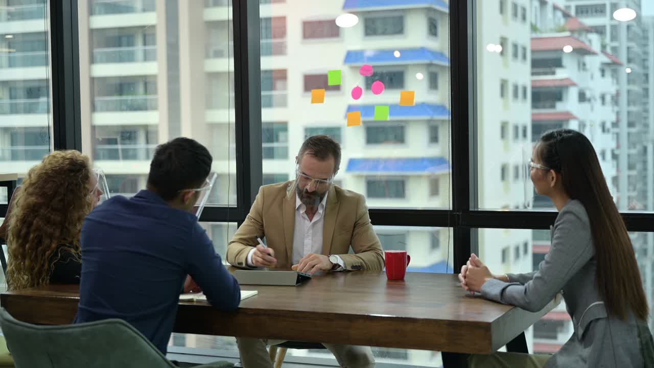 Asian business people team meeting for brainstorm. wearing surgical protective face mask in new normal lifestyle to preventing coronavirus COVID-19 spreading