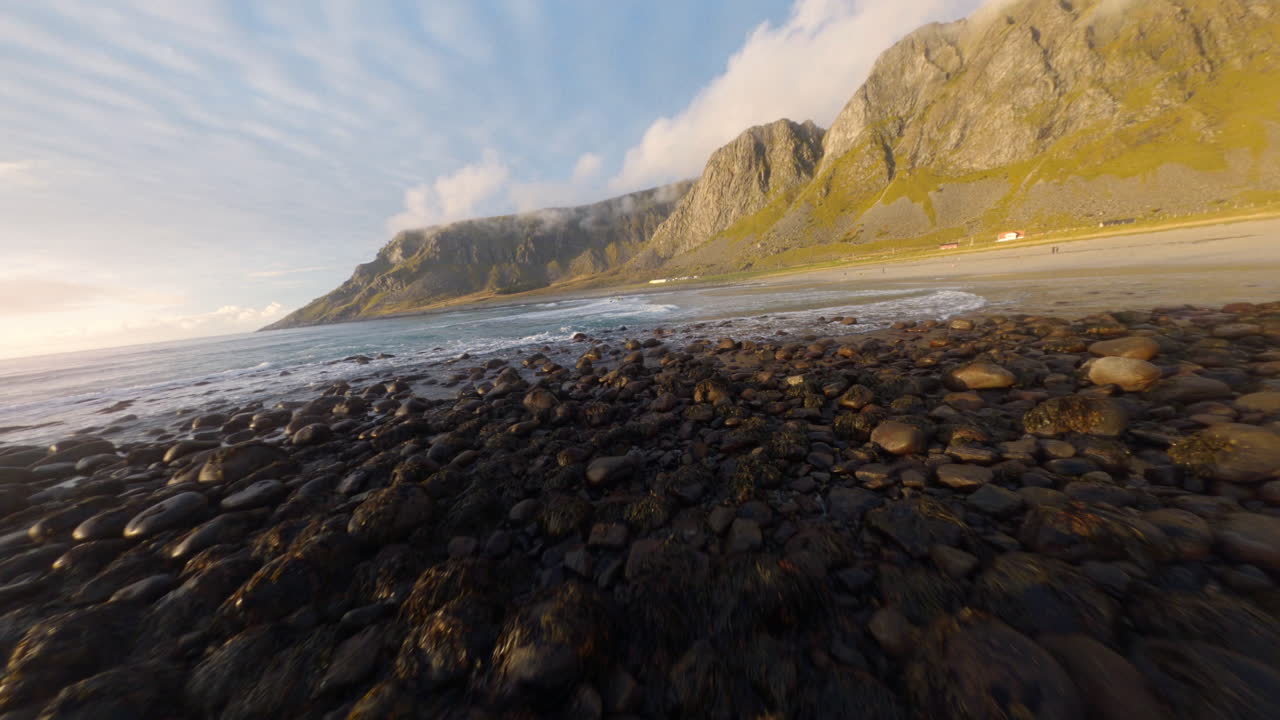 Flying towards the surfer beach of Unstad Lofoten Islands in Norway, impressive low Cinematic FPV drone flight