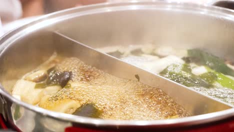 simmering hotpot with vegetables and broth