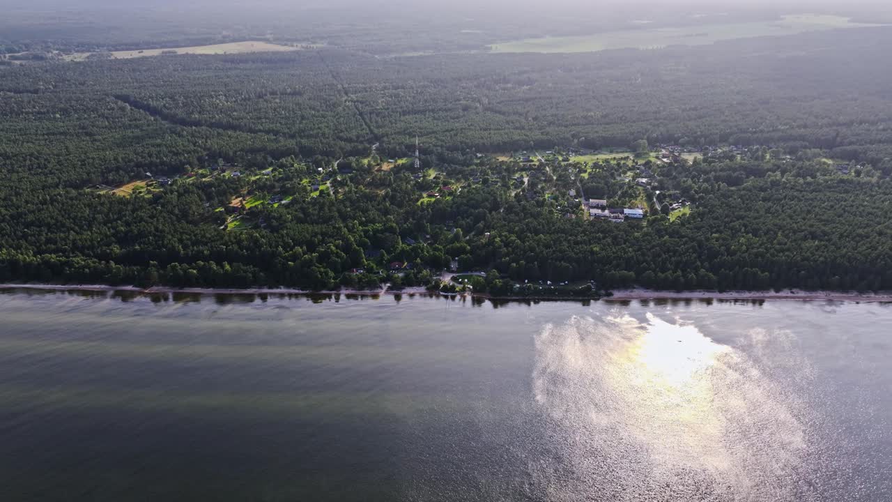 Establishing shot of Latvian seaside Mensils, sunlight reflections, Baltic Sea