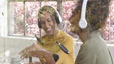 multiracial female colleagues enjoying podcast recording with headphones and microphones at home