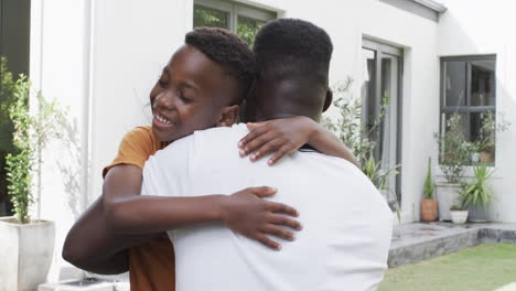 african american father and son share a warm hug outdoors