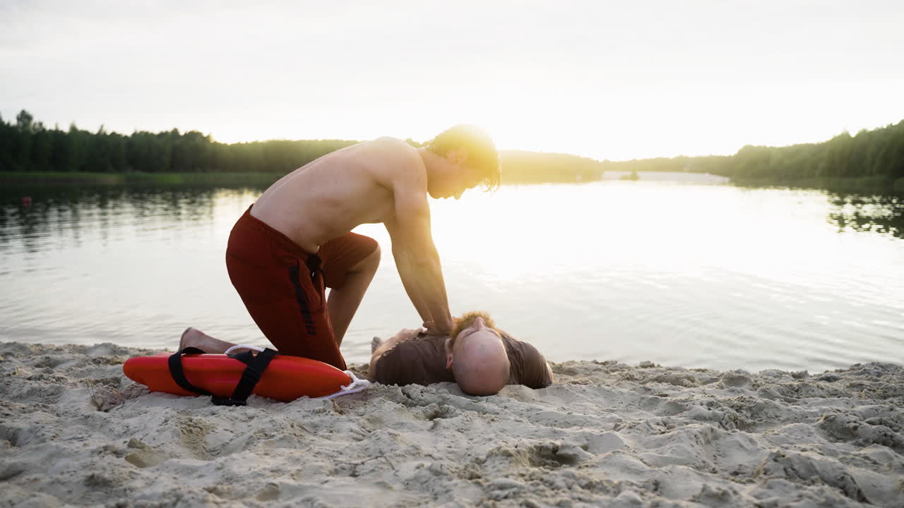 Male lifeguard saving man's life