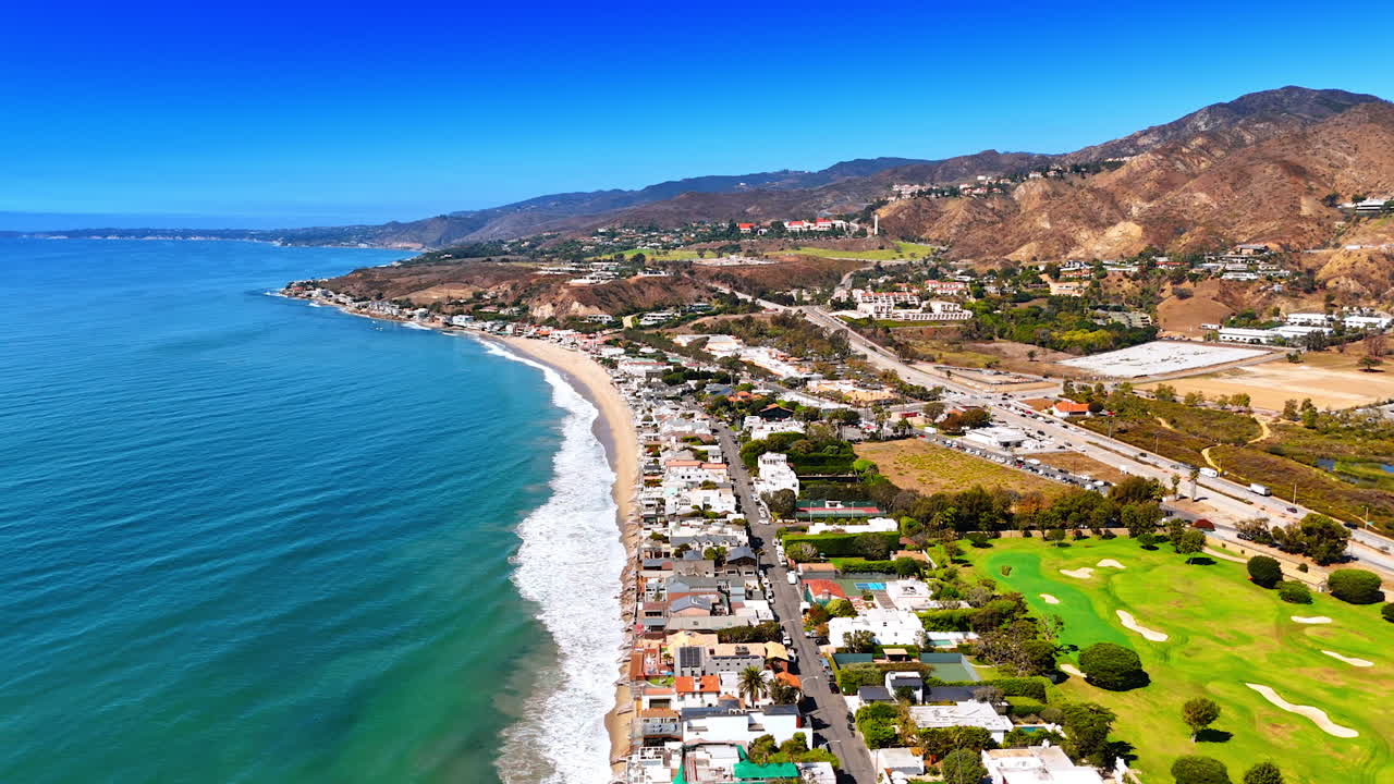 Scenic view on the beautiful shore of Malibu, Los Angeles County, California, USA. Amazing cityscape surrounded by the rocks. Aerial view