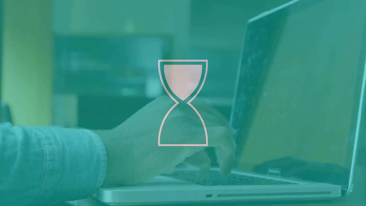 Typing on laptop, hourglass animation over screen