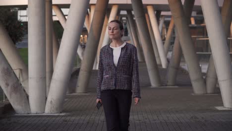 businesswoman using smartphone outside building