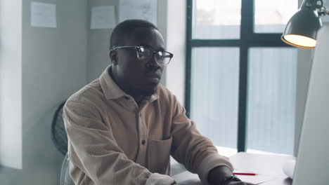 black male architect working on computer in office