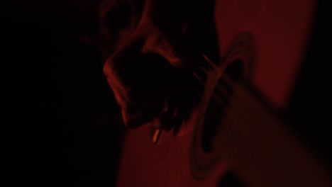 strumming guitar at bonfire