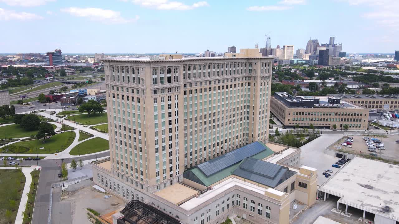 Central Station building in Corktown with skyline of Detroit in background, aerial drone view