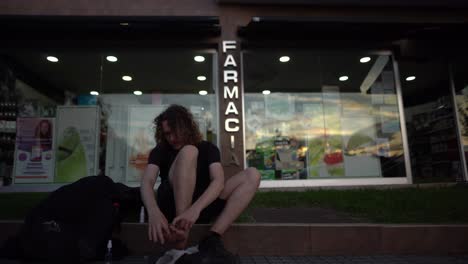 Pilgrim-man-has-pain-and-tapes-his-blisters-at-pharmacy-after-hiking