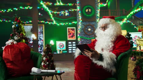 santa claus using a tablet in a modern christmas setting