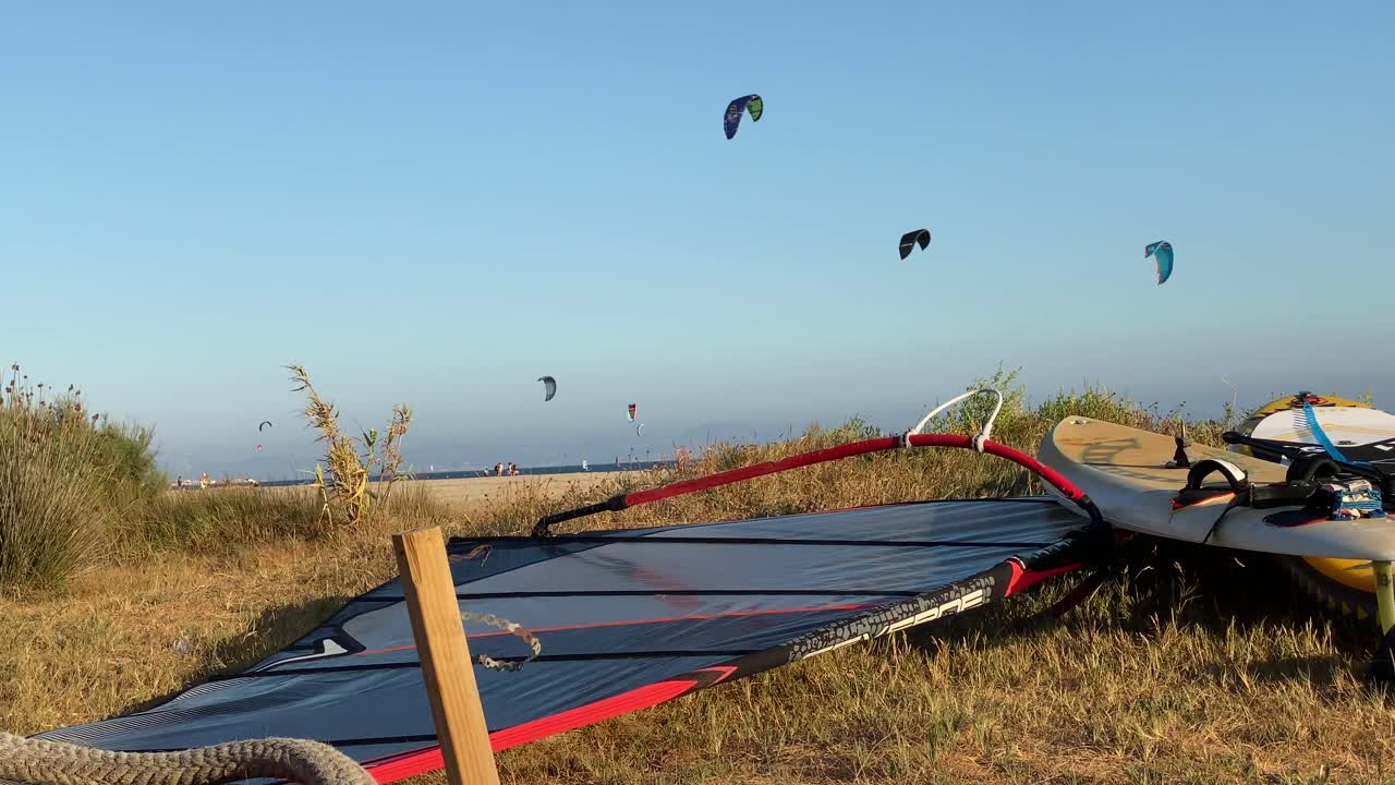 Surfing boards and sails on a beach of Tarifa.