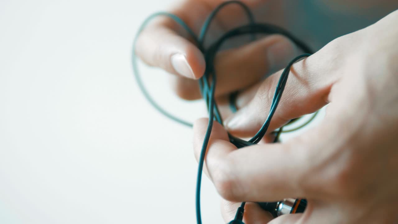 Headphone wire tangled . Unravel the wire and pack it correctly. A convenient way to store headphones. Care for headphones