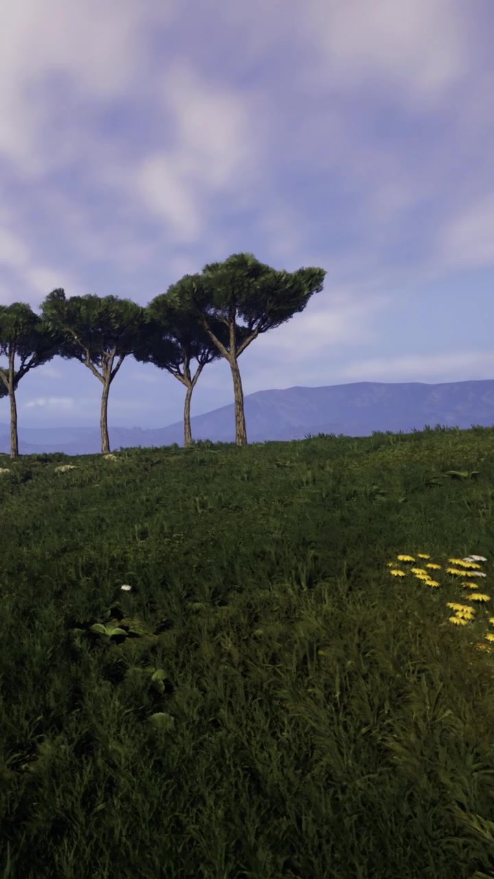 Alberi su una collina verde con montagne sullo sfondo di giorno
