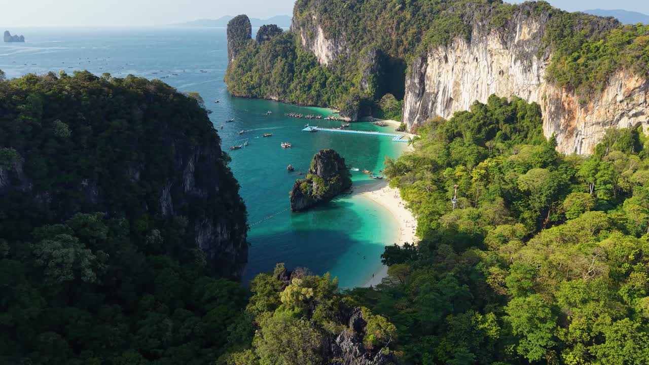 Breathtaking aerial view of Hong Island's pristine beach and turquoise waters, nestled among lush foliage and dramatic limestone cliffs