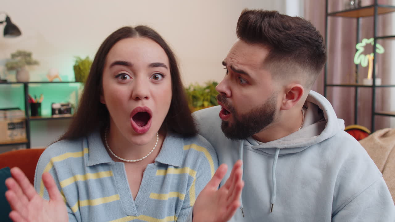 Excited family couple surprised shocked by sudden victory good win news celebrating wow reaction