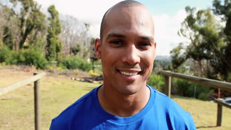 smiling fit man standing in park