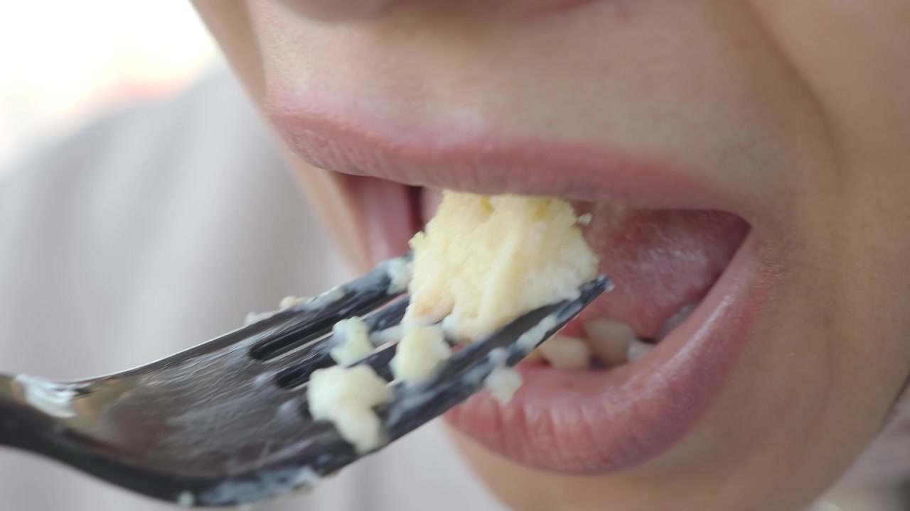 Close-up of a Woman Eating a Piece of Cake