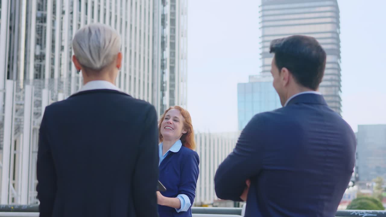 Three business professionals meeting outdoors in a city