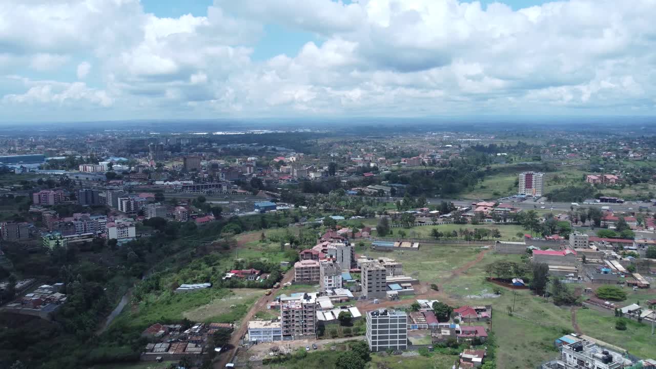 Ruiru, nairobi suburb, showing urban sprawl and greenery under a partly cloudy sky, aerial view