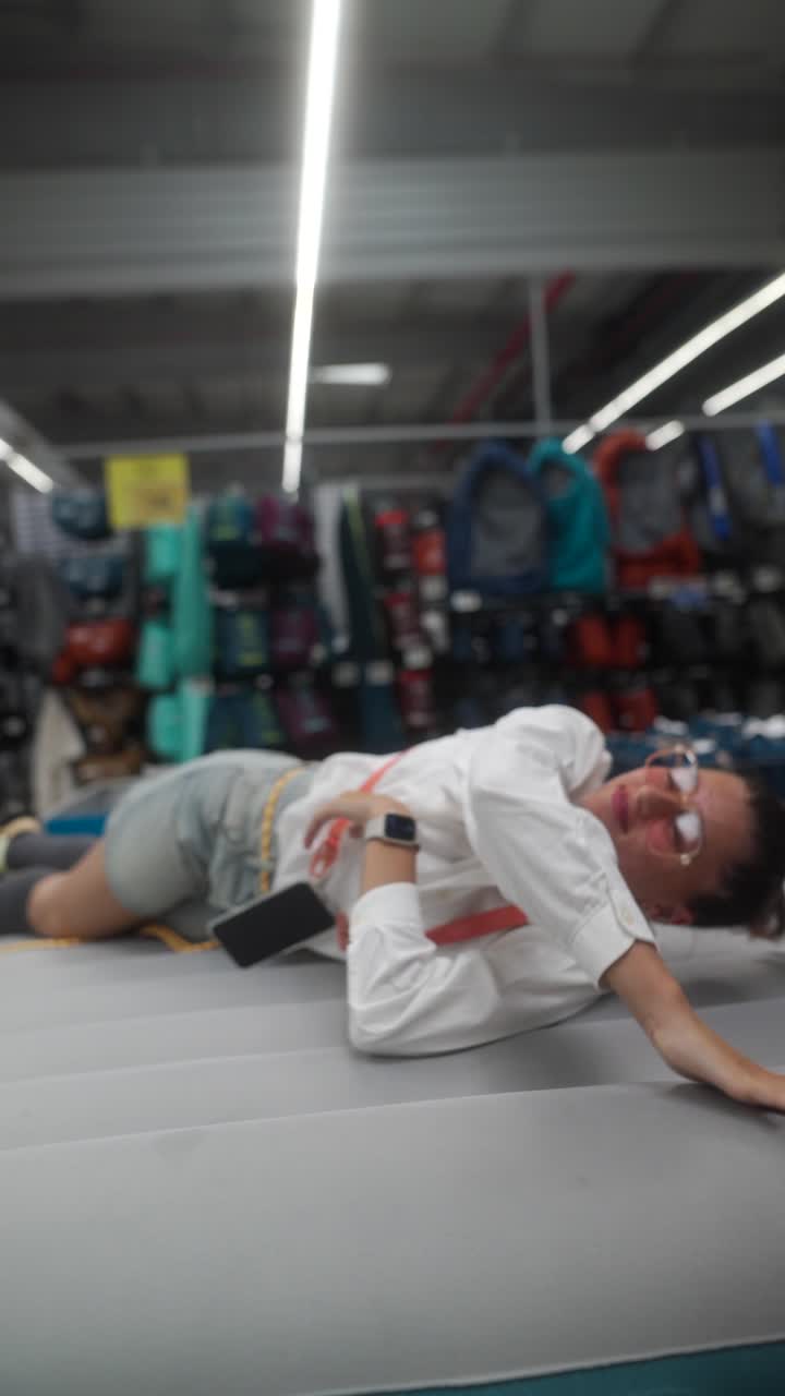 Woman Relaxing on Inflatable Mattress in a Retail Store