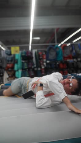 woman relaxing on inflatable mattress in a retail store