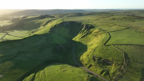 descending aerial view of the winatts pass at sunrise, peak district, uk