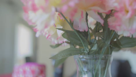 COLORFUL-PLASTIC-FLOWERS-INSIDE-GLASS-VASE-IN-LOW-CONTRAST-HIGH-KEY-IMAGE-BMPCC-4K