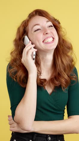 smiling redhead woman on a phone call