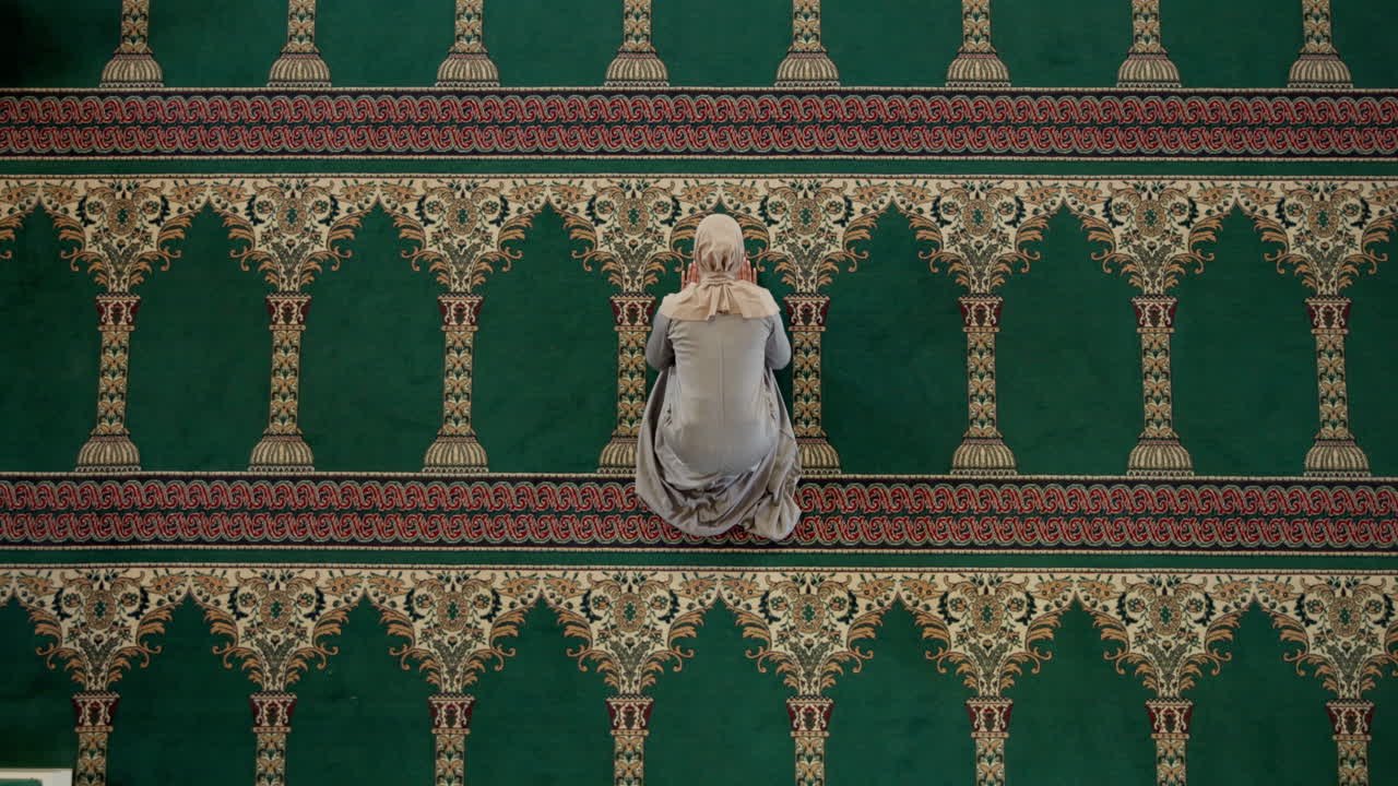 Woman Praying in Mosque on Green Carpet