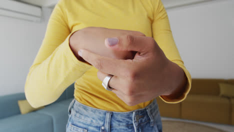 mid section of woman sanitizing her hands