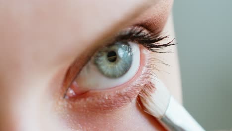 woman applying eye makeup