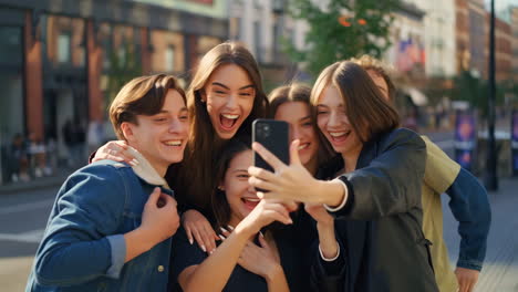group of teenagers taking a selfie on a city street