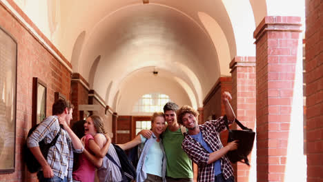 classmates standing in hallway and jumping for joy