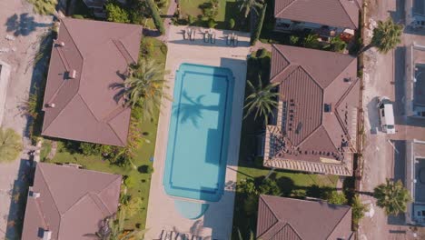 aerial view of residential community with swimming pool and under construction homes