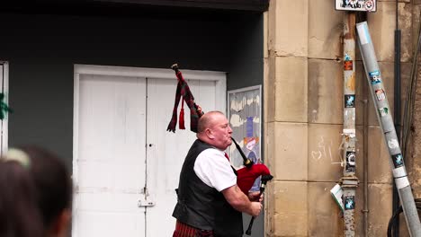 bagpiper performing on edinburgh street