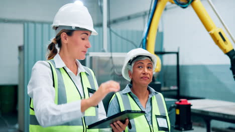 female engineers discussing project in factory