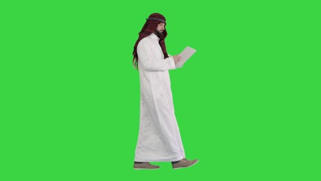 Sheikh presenting information or product using digital tablet on a Green Screen, Chroma Key
