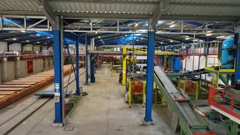 panoramic shot of inside of empty factory with machinery not working