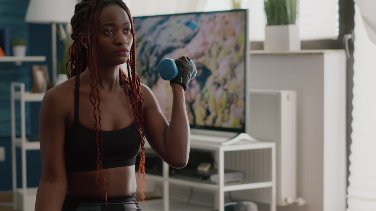 Black slim woman doing aerobic exercices using yoga bands
