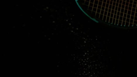 tennis racket hitting a ball on black background